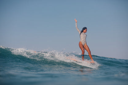 lotta and the waves in coral sands surfsuit